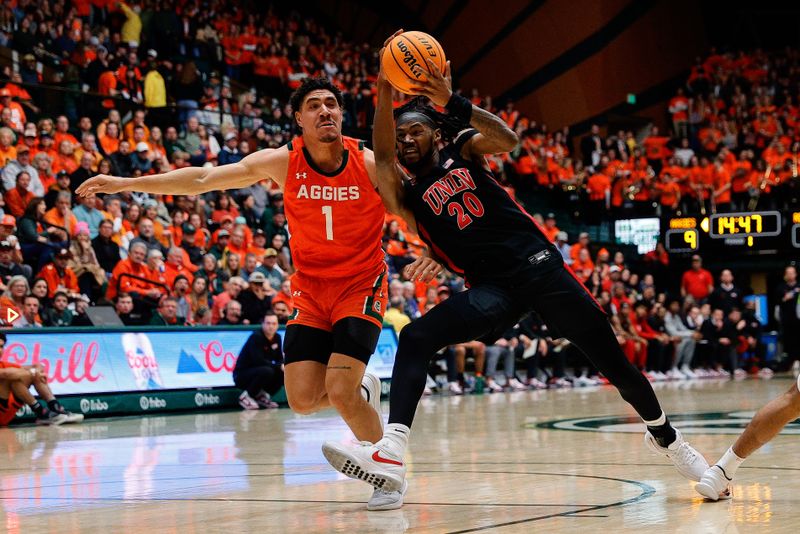 Jan 19, 2024; Fort Collins, Colorado, USA; UNLV Rebels forward Keylan Boone (20) drives to the net against Colorado State Rams forward Joel Scott (1) in the first half at Moby Arena. Mandatory Credit: Isaiah J. Downing-USA TODAY Sports