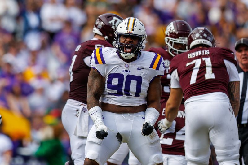 Nov 25, 2023; Baton Rouge, Louisiana, USA;  LSU Tigers defensive tackle Jacobian Guillory (90) reacts to sacking Texas A&M Aggies quarterback Jaylen Henderson (16) during the second half at Tiger Stadium. Mandatory Credit: Stephen Lew-USA TODAY Sports