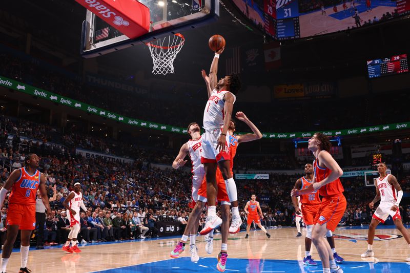 OKLAHOMA CITY, OK - FEBRUARY 27: Amen Thompson #1 of the Houston Rockets rebounds the ball during the game against the Oklahoma City Thunder on February, 2024 at Paycom Arena in Oklahoma City, Oklahoma. NOTE TO USER: User expressly acknowledges and agrees that, by downloading and or using this photograph, User is consenting to the terms and conditions of the Getty Images License Agreement. Mandatory Copyright Notice: Copyright 2024 NBAE (Photo by Zach Beeker/NBAE via Getty Images)