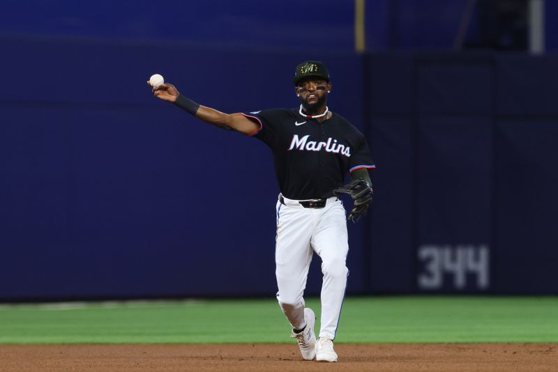 May 17, 2024; Miami, Florida, USA; Miami Marlins shortstop Vidal Brujan (17) throws to first base against the New York Mets during the first inning at loanDepot Park. Mandatory Credit: Sam Navarro-USA TODAY Sports