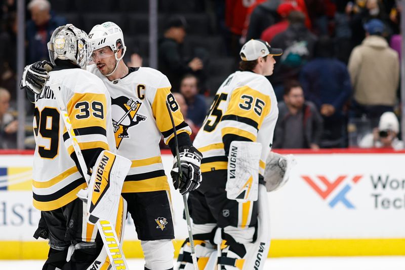 Apr 4, 2024; Washington, District of Columbia, USA; Pittsburgh Penguins center Sidney Crosby (87) celebrates with Penguins goaltender Alex Nedeljkovic (39) after their game against the Washington Capitals at Capital One Arena. Mandatory Credit: Geoff Burke-USA TODAY Sports