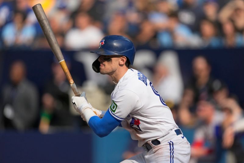 Sep 17, 2023; Toronto, Ontario, CAN; Toronto Blue Jays right fielder Cavan Biggio (8) hits a single against the Boston Red Sox during the ninth inning at Rogers Centre. Mandatory Credit: John E. Sokolowski-USA TODAY Sports