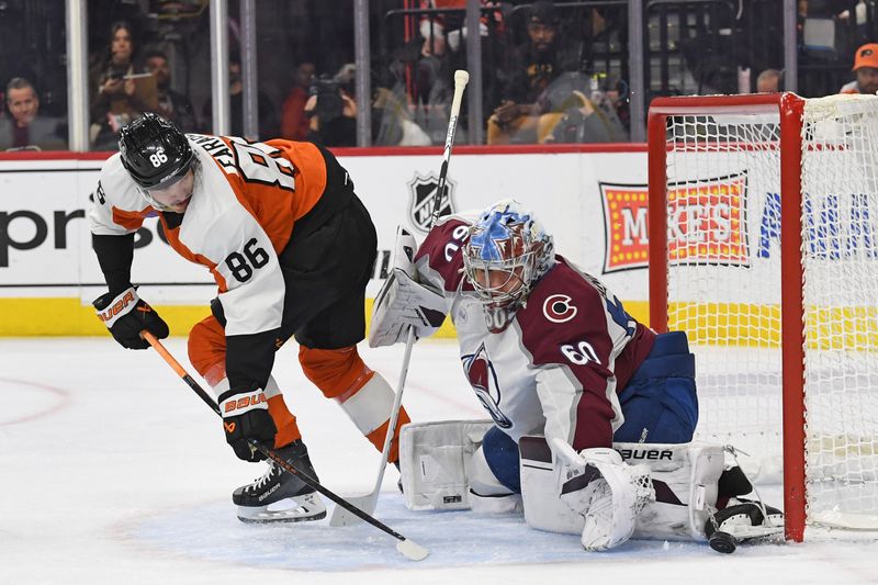 Nov 18, 2024; Philadelphia, Pennsylvania, USA; Colorado Avalanche goaltender Justus Annunen (60) makes a save against Philadelphia Flyers left wing Joel Farabee (86) during the first period at Wells Fargo Center. Mandatory Credit: Eric Hartline-Imagn Images