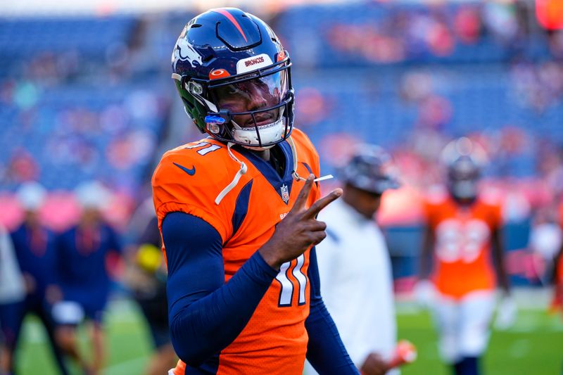 Denver Broncos quarterback Josh Johnson (11) warms up against the Minnesota Vikings during an NFL preseason football game, Saturday, Aug. 27, 2022, in Denver. (AP Photo/Jack Dempsey)