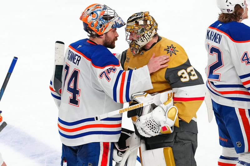May 14, 2025; Las Vegas, Nevada, USA; Edmonton Oilers goaltender Stuart Skinner (74) shakes hands with Vegas Golden Knights goaltender Adin Hill (33) after the Oilers defeated the Vegas Golden Knights 1-0 during an overtime period, completing a 4-1 series win during game five of the second round of the 2025 Stanley Cup Playoffs at T-Mobile Arena. Mandatory Credit: Stephen R. Sylvanie-Imagn Images