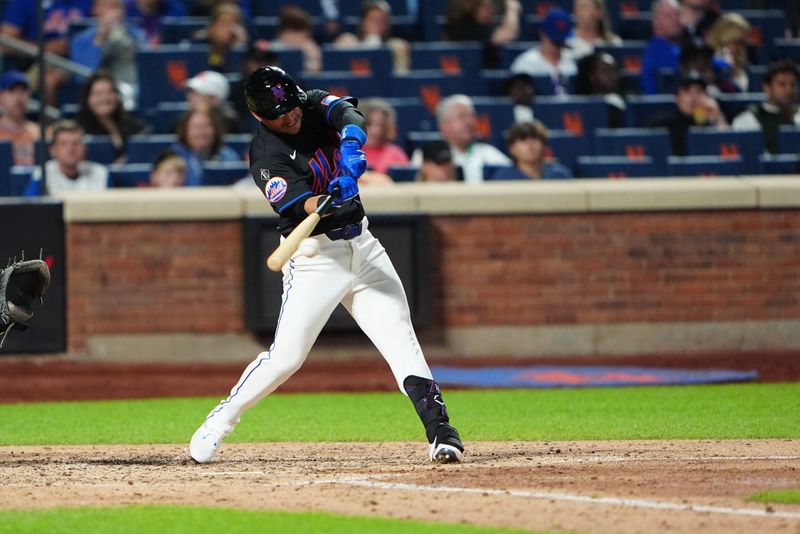 May 31, 2024; New York City, New York, USA; New York Mets second baseman Jose Iglesias (11) hits a single against the Arizona Diamondbacks during the fifth inning at Citi Field. Mandatory Credit: Gregory Fisher-USA TODAY Sports