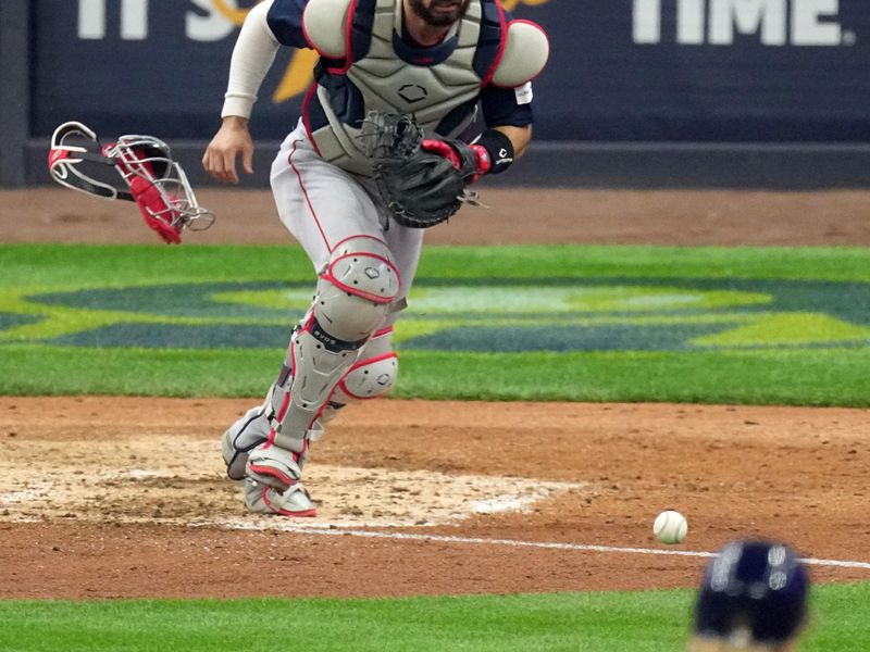 Apr 23, 2023; Milwaukee, Wisconsin, USA; Boston Red Sox catcher Connor Wong (12) runs down a bunt hit by Milwaukee Brewers center fielder Blake Perkins during the seventh inning of their game at American Family Field. Mandatory Credit: Mark Hoffman-USA TODAY Sports