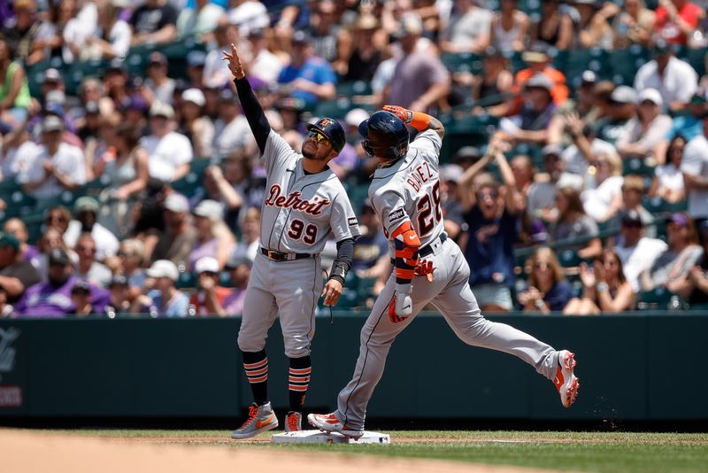 Jul 2, 2023; Denver, Colorado, USA; Detroit Tigers shortstop Javier Baez (28) celebrates with first base coach Alfredo Amezaga (99) as he rounds the bases on a grand slam in the first inning against the Colorado Rockies at Coors Field. Mandatory Credit: Isaiah J. Downing-USA TODAY Sports