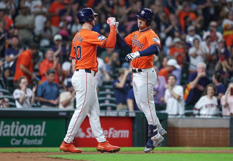 Sep 20, 2024; Houston, Texas, USA; Houston Astros third baseman Alex Bregman (2) celebrates with right fielder Kyle Tucker (30) after hitting a home run during the third inning at Minute Maid Park. Mandatory Credit: Troy Taormina-Imagn Images