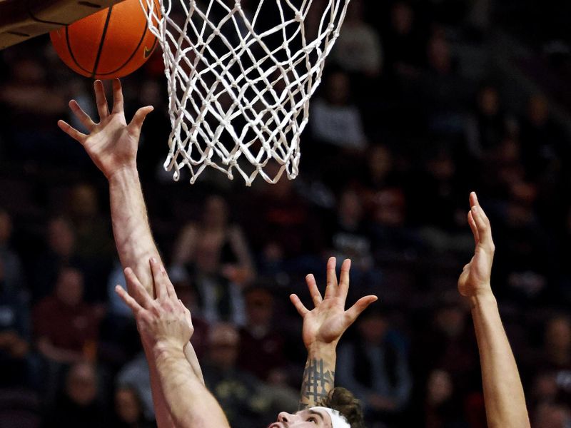 Jan 23, 2024; Blacksburg, Virginia, USA; Boston College Eagles forward Quinten Post (12) shoots the ball against Virginia Tech Hokies center Lynn Kidd (15) during the first half at Cassell Coliseum. Mandatory Credit: Peter Casey-USA TODAY Sports