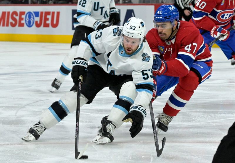 Nov 26, 2024; Montreal, Quebec, CAN; Utah Hockey Club forward Michael Carcone (53) plays the puck against Montreal Canadiens defenseman Jayden Struble (47) during the second period at the Bell Centre. Mandatory Credit: Eric Bolte-Imagn Images