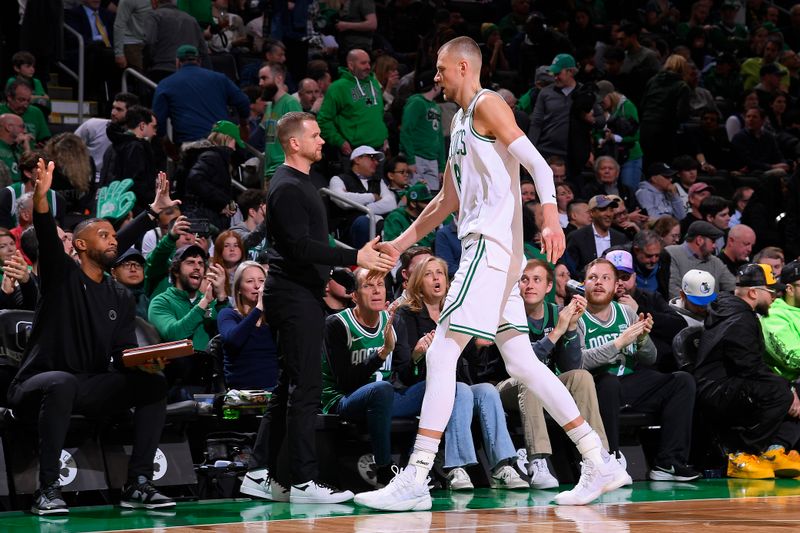 BOSTON, MA - APRIL 3: Kristaps Porzingis #8 of the Boston Celtics high fives coaching staff during the game against the Oklahoma City Thunder on April 3, 2024 at the TD Garden in Boston, Massachusetts. NOTE TO USER: User expressly acknowledges and agrees that, by downloading and or using this photograph, User is consenting to the terms and conditions of the Getty Images License Agreement. Mandatory Copyright Notice: Copyright 2024 NBAE  (Photo by Brian Babineau/NBAE via Getty Images)