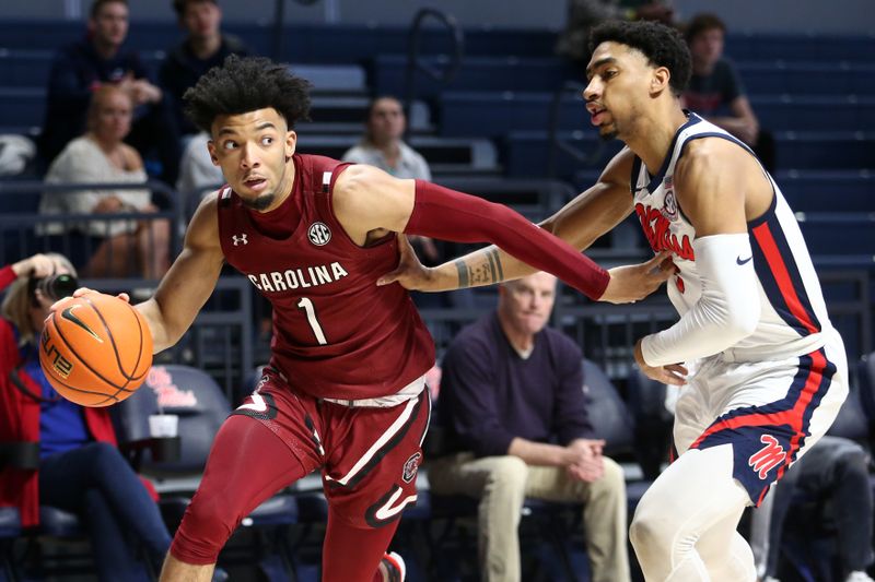 Feb 11, 2023; Oxford, Mississippi, USA; South Carolina Gamecocks guard Jacobi Wright (1) drives to the basket as Mississippi Rebels forward Myles Burns (3) defends during the first half at The Sandy and John Black Pavilion at Ole Miss. Mandatory Credit: Petre Thomas-USA TODAY Sports