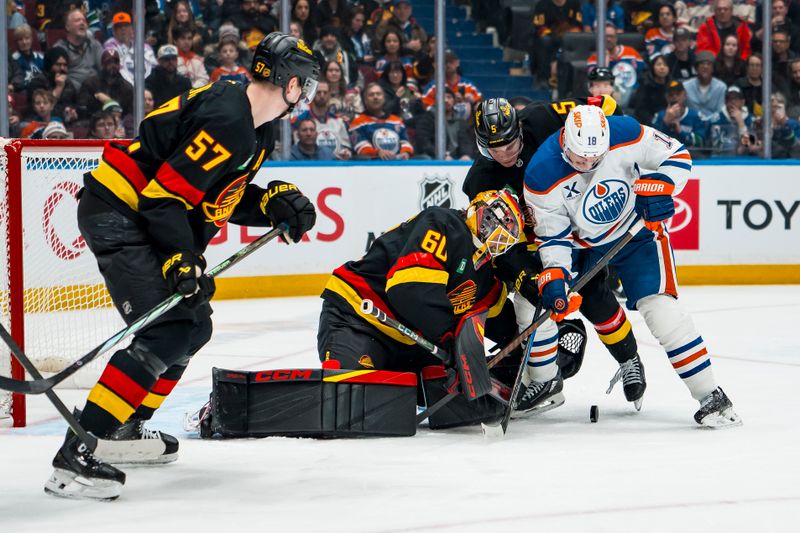 Jan 17, 2026; Vancouver, British Columbia, CAN; Vancouver Canucks defenseman Tyler Myers (57) watches as goalie Nikita Tolopilo (60) and defenseman Tom Willander (5) battle with Edmonton Oilers forward Zach Hyman (18) in the third period at Rogers Arena. Mandatory Credit: Bob Frid-Imagn Images