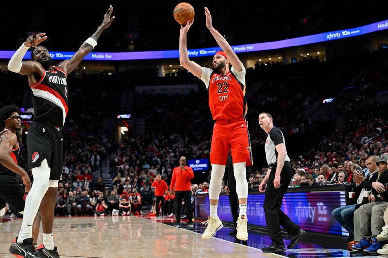 PORTLAND, OREGON - APRIL 09: Larry Nance Jr. #22 of the New Orleans Pelicans attempts a three point basket against Deandre Ayton #2 of the Portland Trail Blazers during the third quarter of the game at the Moda Center on April 09, 2024 in Portland, Oregon. The New Orleans Pelicans won 110-100. NOTE TO USER: User expressly acknowledges and agrees that, by downloading and or using this photograph, User is consenting to the terms and conditions of the Getty Images License Agreement. (Photo by Alika Jenner/Getty Images)