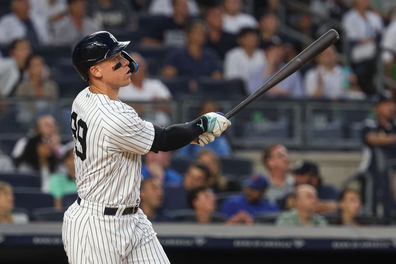 Aug 23, 2023; Bronx, New York, USA; New York Yankees right fielder Aaron Judge (99) hits a grand slam home run during the second inning against the Washington Nationals at Yankee Stadium. Mandatory Credit: Vincent Carchietta-USA TODAY Sports