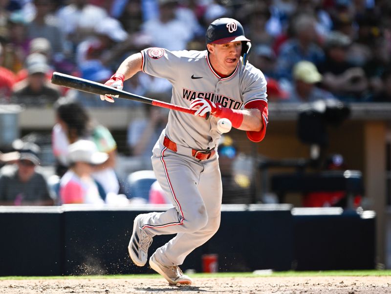 Jun 25, 2025; San Diego, California, USA; Washington Nationals center fielder Jacob Young (30) tries to avoid the ball as he runs out a bunt during the eighth inning against the San Diego Padres at Petco Park. Young was out on the play.  Mandatory Credit: Denis Poroy-Imagn Images