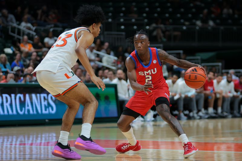 Jan 18, 2025; Coral Gables, Florida, USA; Southern Methodist Mustangs guard Boopie Miller (2) drives to the basket against Miami Hurricanes guard Austin Swartz (23) during the first half at Watsco Center. Mandatory Credit: Sam Navarro-Imagn Images
