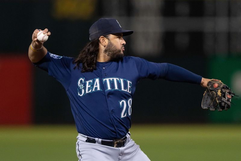 Sep 18, 2023; Oakland, California, USA;  Seattle Mariners third baseman Eugenio Suarez (28) throws the ball during the fourth inning against the Oakland Athletics at Oakland-Alameda County Coliseum. Mandatory Credit: Stan Szeto-USA TODAY Sports