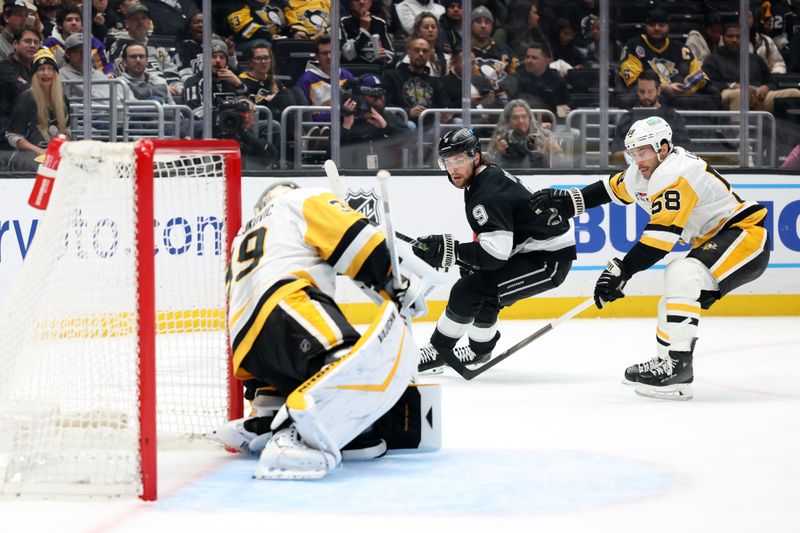 Jan 20, 2025; Los Angeles, California, USA;  Los Angeles Kings right wing Adrian Kempe (9) shoots the puck as Pittsburgh Penguins defenseman Kris Letang (58) defends during the second period at Crypto.com Arena. Mandatory Credit: Kiyoshi Mio-Imagn Images