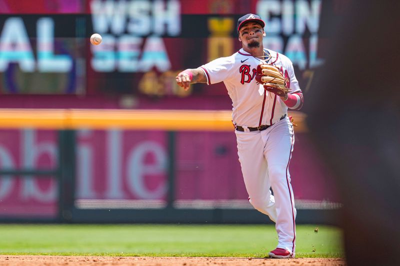 Jun 28, 2023; Cumberland, Georgia, USA; Atlanta Braves shortstop Orlando Arcia (11) throws to first base to retire Minnesota Twins third baseman Kyle Farmer (12) (not shown) during the second inning at Truist Park. Mandatory Credit: Dale Zanine-USA TODAY Sports