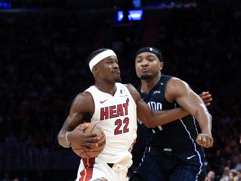 MIAMI, FLORIDA - OCTOBER 23: Jimmy Butler #22 of the Miami Heat drives past Wendell Carter Jr. #34 of the Orlando Magic during the second half at Kaseya Center on October 23, 2024 in Miami, Florida. NOTE TO USER: User expressly acknowledges and agrees that, by downloading and or using this photograph, User is consenting to the terms and conditions of the Getty Images License Agreement. (Photo by Carmen Mandato/Getty Images)