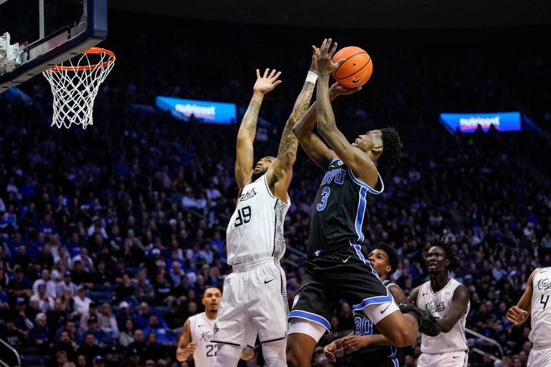 Feb 24, 2026; Provo, Utah, USA; BYU Cougars forward AJ Dybantsa (3) drives to the basket while being defended by UCF Knights forward Jordan Burks (99) during the first half  at Marriott Center. Mandatory Credit: Aaron Baker-Imagn Images 