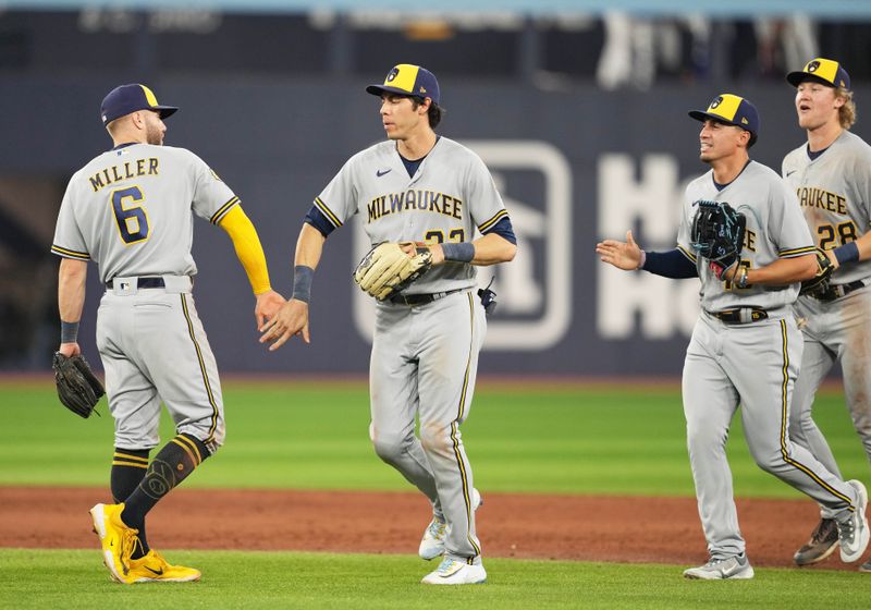 May 31, 2023; Toronto, Ontario, CAN; Milwaukee Brewers left fielder Christian Yelich (22) celebrates a win with second baseman Owen Miller (6) against the Toronto Blue Jays at Rogers Centre. Mandatory Credit: Nick Turchiaro-USA TODAY Sports