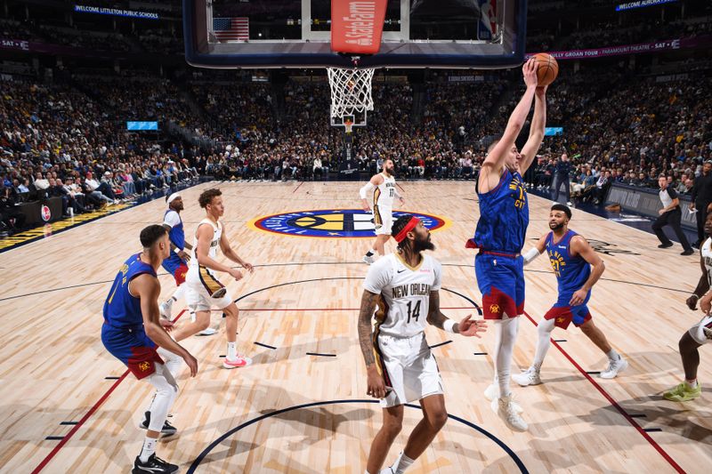 DENVER, CO - JANUARY 12: Nikola Jokic #15 of the Denver Nuggets grabs a rebound during the game against the New Orleans Pelicans  on January 12, 2024 at the Ball Arena in Denver, Colorado. NOTE TO USER: User expressly acknowledges and agrees that, by downloading and/or using this Photograph, user is consenting to the terms and conditions of the Getty Images License Agreement. Mandatory Copyright Notice: Copyright 2024 NBAE (Photo by Garrett Ellwood/NBAE via Getty Images)