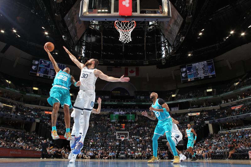 MEMPHIS, TN - OCTOBER 10: Tre Mann #23 of the Charlotte Hornets shoots the ball defended by Jay Huff #30 of the Memphis Grizzlies during a NBA Preseason game on October 10, 2024 at FedExForum in Memphis, Tennessee. NOTE TO USER: User expressly acknowledges and agrees that, by downloading and or using this photograph, User is consenting to the terms and conditions of the Getty Images License Agreement. Mandatory Copyright Notice: Copyright 2024 NBAE (Photo by Joe Murphy/NBAE via Getty Images)