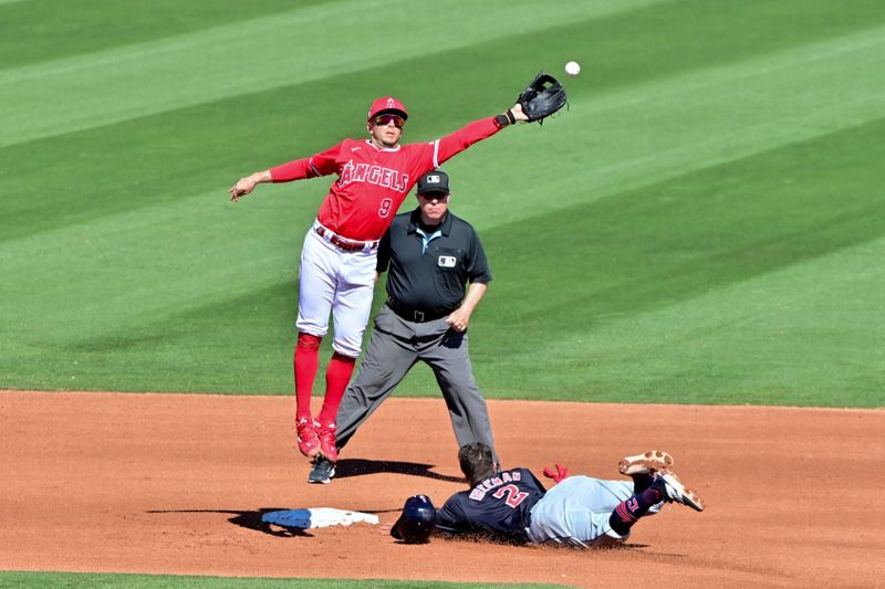 Feb 29, 2024; Tempe, Arizona, USA;  Los Angeles Angels shortstop Zach Neto (9) misses the catch as Cleveland Guardians third baseman Tyler Freeman (2) steals a base in the third inning during a spring training game at Tempe Diablo Stadium. Mandatory Credit: Matt Kartozian-USA TODAY Sports