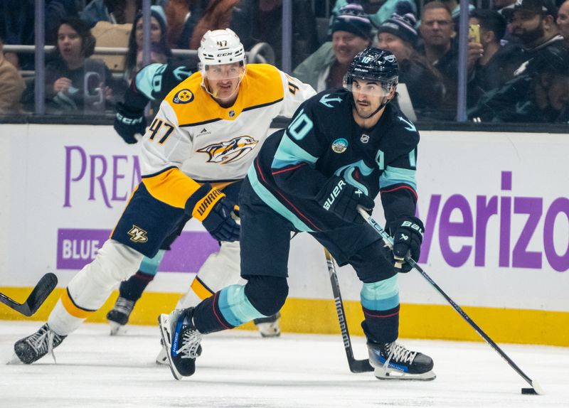 Nov 20, 2024; Seattle, Washington, USA;  Seattle Kraken forward Matty Beniers (10) skates against Nashville Predators forward Michael McCarron (47) during the first period at Climate Pledge Arena. Mandatory Credit: Stephen Brashear-Imagn Images