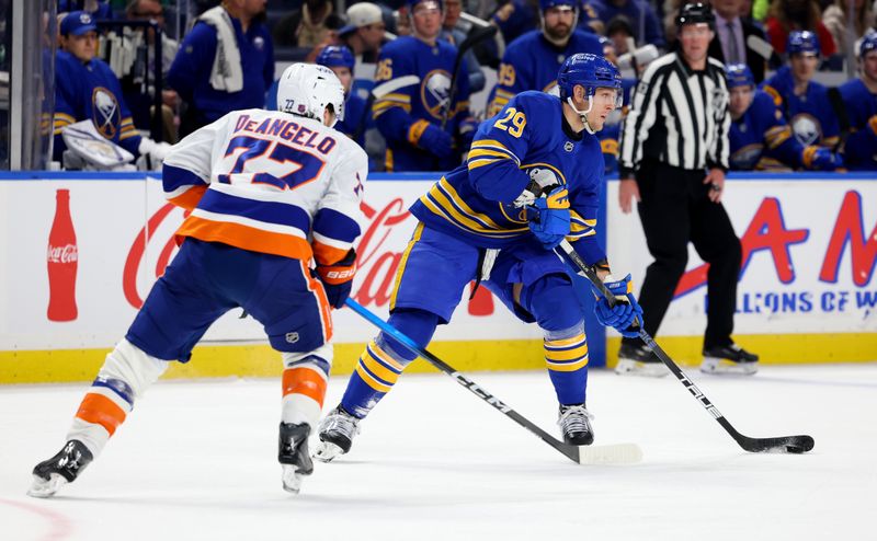 Dec 20, 2025; Buffalo, New York, USA;  Buffalo Sabres left wing Beck Malenstyn (29) looks to pass as New York Islanders defenseman Tony Deangelo (77) defends during the second period at KeyBank Center. Mandatory Credit: Timothy T. Ludwig-Imagn Images