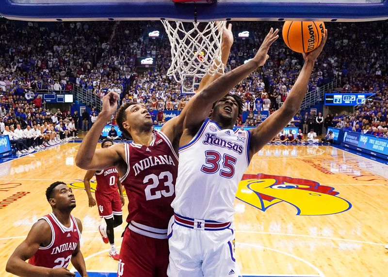 Dec 17, 2022; Lawrence, Kansas, USA; Kansas Jayhawks forward Zuby Ejiofor (35) shoots against Indiana Hoosiers forward Trayce Jackson-Davis (23) and forward Jordan Geronimo (22) during the first half at Allen Fieldhouse. Mandatory Credit: Jay Biggerstaff-USA TODAY Sports