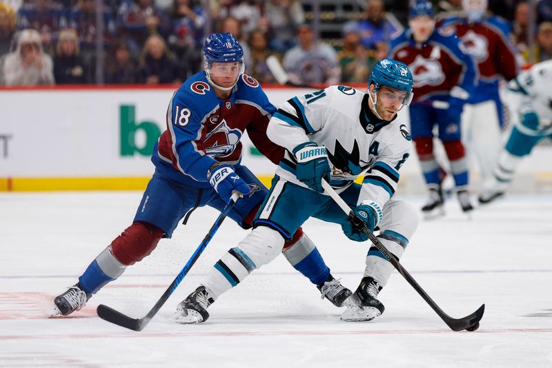 Feb 4, 2026; Denver, Colorado, USA; San Jose Sharks center Alexander Wennberg (21) controls the puck under pressure from Colorado Avalanche center Jack Drury (18) in the second period at Ball Arena. Mandatory Credit: Isaiah J. Downing-Imagn Images
