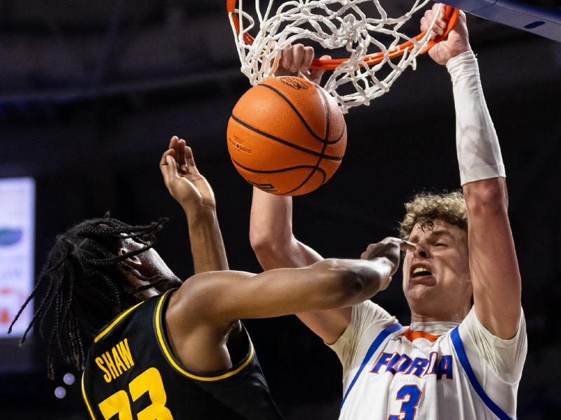 Feb 28, 2024; Gainesville, Florida, USA; Florida Gators center Micah Handlogten (3) dunks the ball over Missouri Tigers forward Aidan Shaw (23) during the second half at Exactech Arena at the Stephen C. O'Connell Center. Mandatory Credit: Matt Pendleton-USA TODAY Sports