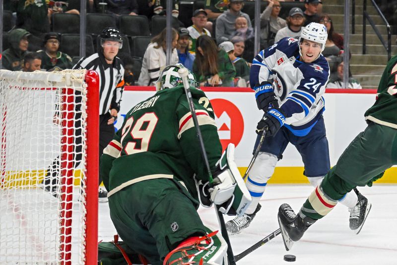 Sep 27, 2024; Saint Paul, Minnesota, USA;  Winnipeg Jets defenseman Haydn Fleury (24) takes a shot on goal against the Minnesota Wild during the first period at Xcel Energy Center. Mandatory Credit: Nick Wosika-Imagn Images

