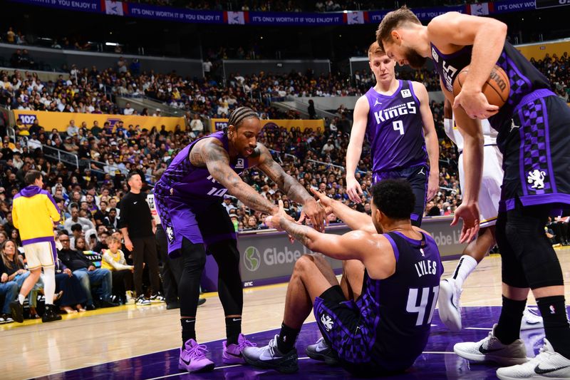 LOS ANGELES, CA - OCTOBER 26: DeMar DeRozan #10 helps up Trey Lyles #41 of the Sacramento Kings during the game against the Los Angeles Lakers on October 26, 2024 at Crypto.Com Arena in Los Angeles, California. NOTE TO USER: User expressly acknowledges and agrees that, by downloading and/or using this Photograph, user is consenting to the terms and conditions of the Getty Images License Agreement. Mandatory Copyright Notice: Copyright 2024 NBAE (Photo by Adam Pantozzi/NBAE via Getty Images)