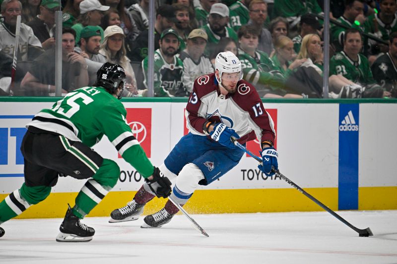 May 7, 2024; Dallas, Texas, USA; Colorado Avalanche right wing Valeri Nichushkin (13) skates with the puck past Dallas Stars defenseman Thomas Harley (55) during the first period in game one of the second round of the 2024 Stanley Cup Playoffs at American Airlines Center. Mandatory Credit: Jerome Miron-USA TODAY Sports