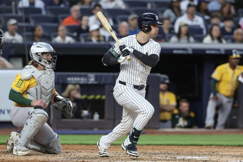 Jun 27, 2025; Bronx, New York, USA;  New York Yankees left fielder Cody Bellinger (35) hits an RBI single in the third inning against the Athletics at Yankee Stadium. Mandatory Credit: Wendell Cruz-Imagn Images
