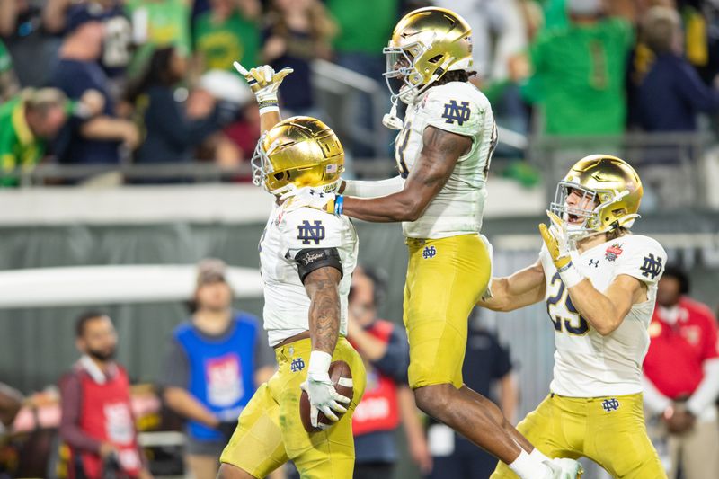 Dec 30, 2022; Jacksonville, FL, USA; Notre Dame Fighting Irish running back Logan Diggs (3), wide receiver Jayden Thomas (83) and wide receiver Matt Salerno (29) celebrate a touchdown against the South Carolina Gamecocks in the fourth quarter in the 2022 Gator Bowl at TIAA Bank Field. Mandatory Credit: Jeremy Reper-USA TODAY Sports