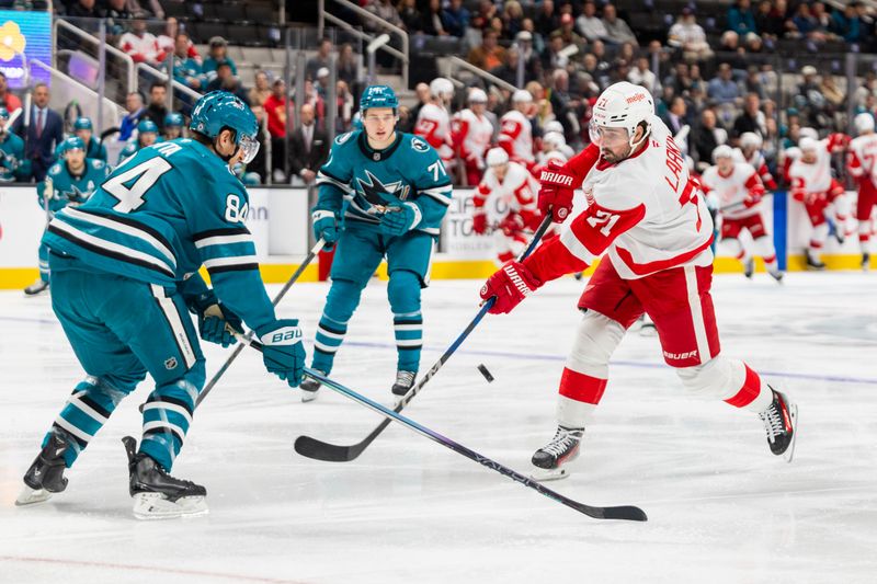 Nov 18, 2024; San Jose, California, USA; Detroit Red Wings center Dylan Larkin (71) shoots the puck during the first period against the San Jose Sharks at SAP Center at San Jose. Mandatory Credit: Bob Kupbens-Imagn Images