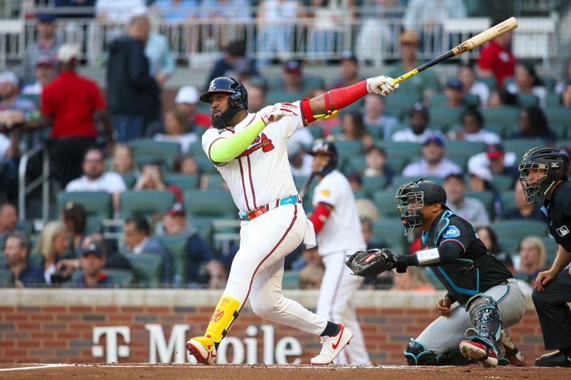 Apr 24, 2024; Atlanta, Georgia, USA; Atlanta Braves designated hitter Marcell Ozuna (20) hits a RBI single against the Miami Marlins in the first inning at Truist Park. Mandatory Credit: Brett Davis-USA TODAY Sports