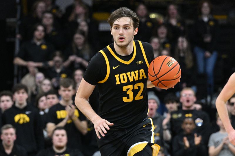 Feb 17, 2024; Iowa City, Iowa, USA; Iowa Hawkeyes forward Owen Freeman (32) brings the ball up court against the Wisconsin Badgers during the second half at Carver-Hawkeye Arena. Mandatory Credit: Jeffrey Becker-USA TODAY Sports