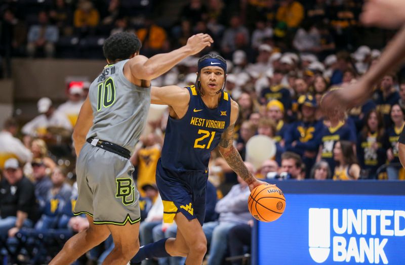 Feb 17, 2024; Morgantown, West Virginia, USA; West Virginia Mountaineers guard RaeQuan Battle (21) drives against Baylor Bears guard RayJ Dennis (10) during the second half at WVU Coliseum. Mandatory Credit: Ben Queen-USA TODAY Sports