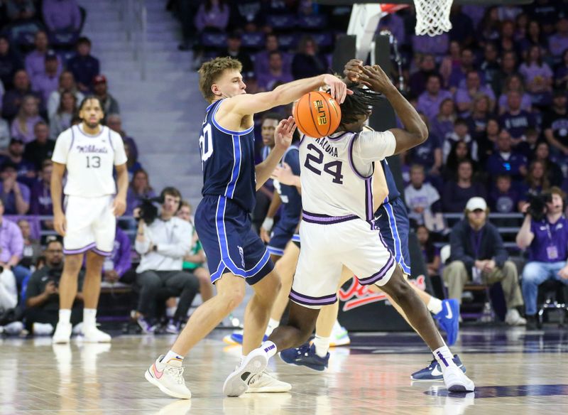 Feb 24, 2024; Manhattan, Kansas, USA; Brigham Young Cougars guard Spencer Johnson (20) steals the ball from Kansas State Wildcats forward Arthur Maluma (24) during the second half at Bramlage Coliseum. Mandatory Credit: Scott Sewell-USA TODAY Sports