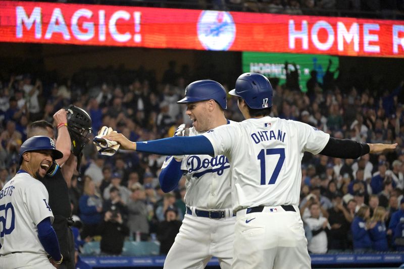 May 20, 2024; Los Angeles, California, USA;  Los Angeles Dodgers first baseman Freddie Freeman (5) is greeted at the plate by shortstop Mookie Betts (50) and designated hitter Shohei Ohtani (17) after hitting a grand slam home run in the third inning against the Arizona Diamondbacks at Dodger Stadium. Mandatory Credit: Jayne Kamin-Oncea-USA TODAY Sports