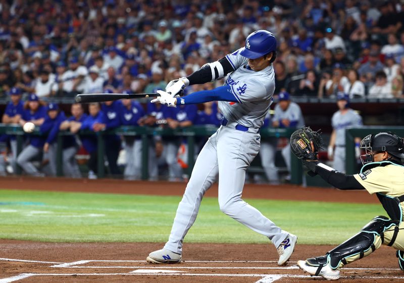 Apr 30, 2024; Phoenix, Arizona, USA; Los Angeles Dodgers designated hitter Shohei Ohtani hits a single in the first inning against the Arizona Diamondbacks at Chase Field. Mandatory Credit: Mark J. Rebilas-USA TODAY Sports