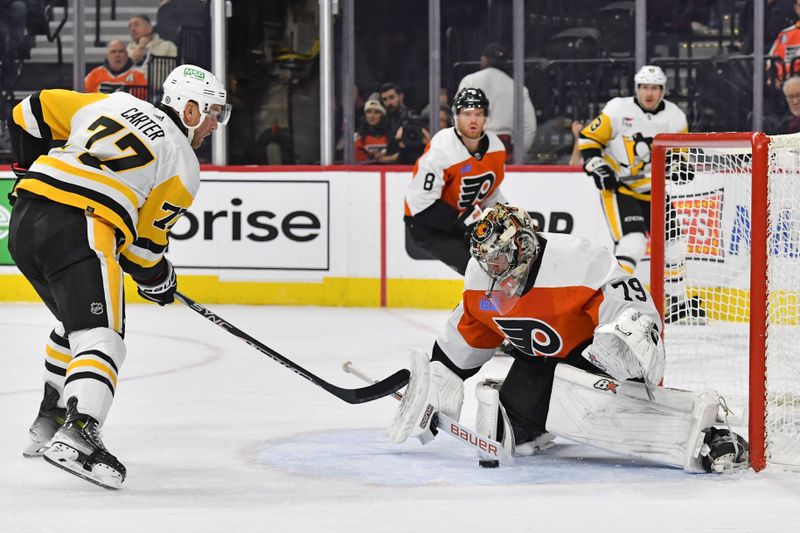 Jan 8, 2024; Philadelphia, Pennsylvania, USA; Philadelphia Flyers goaltender Carter Hart (79) makes a save against Pittsburgh Penguins center Jeff Carter (77) during the second period at Wells Fargo Center. Mandatory Credit: Eric Hartline-USA TODAY Sports