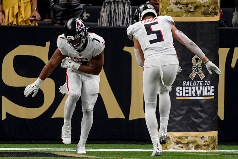 Atlanta Falcons running back Bijan Robinson (7) celebrates his touchdown run with wide receiver Drake London (5) during the second half of an NFL football game against the New Orleans Saints, Sunday, Nov. 10, 2024, in New Orleans. (AP Photo/Gerald Herbert)